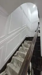 Gorgeous full wall wainscoting on a staircase in the house in Milton
